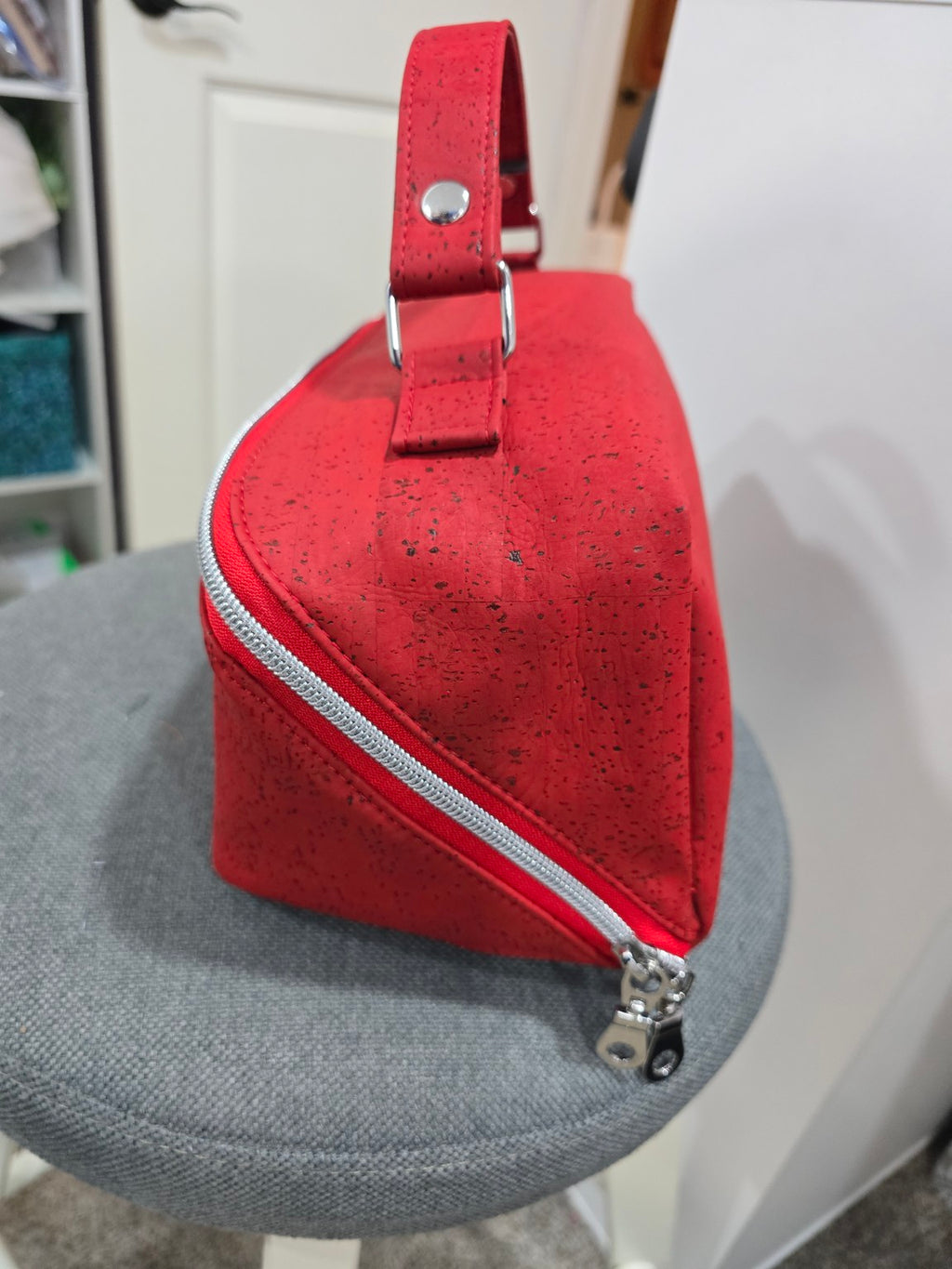 Red cork Charles Dopp Kit side view showing handle and silver zipper