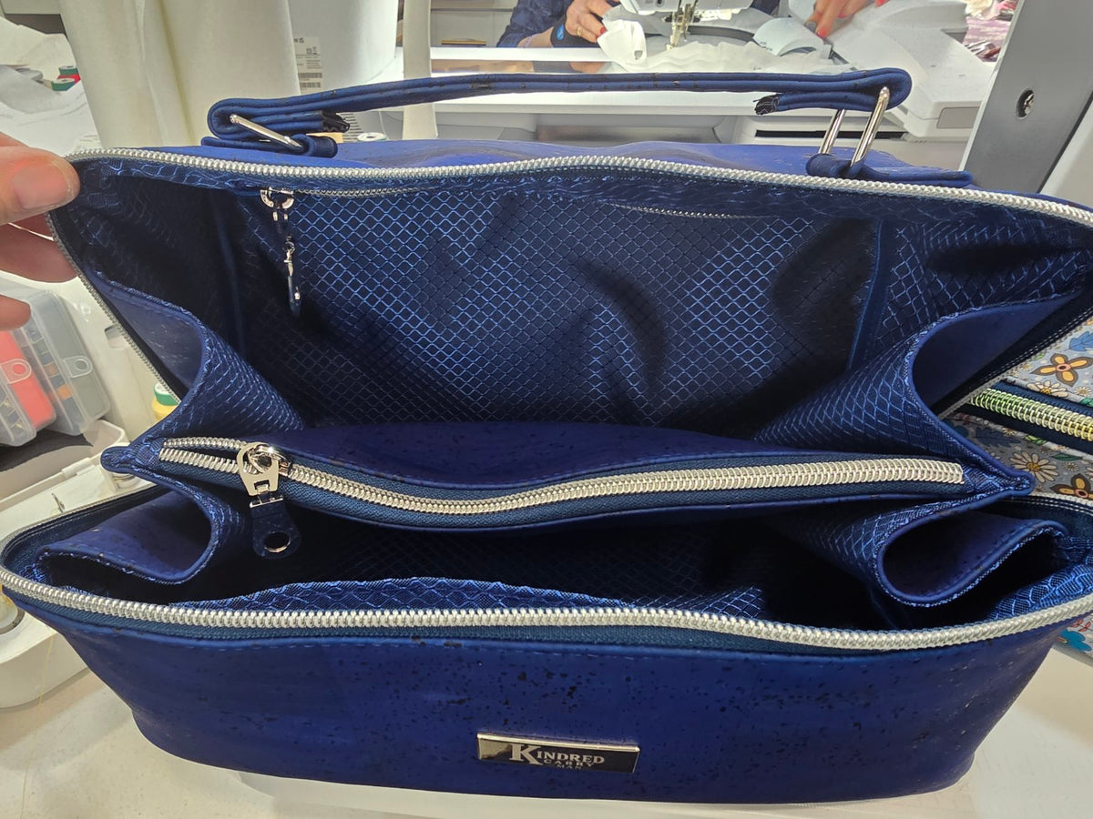 Charles Dopp Kit opened wide to show blue geometric ripstop lining, center zipper divider, interior zipper pocket and slip pockets