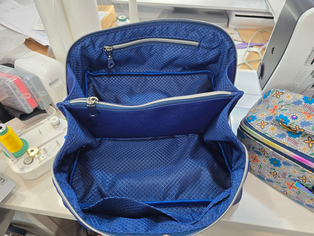 Top view inside Royal Blue Cork Charles Dopp Kit showing blue patterned lining, organized compartments and zippered divider