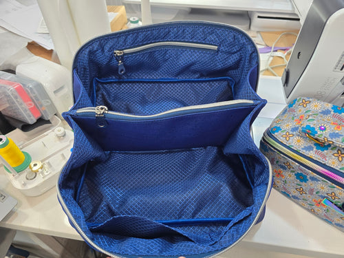 Top view inside Royal Blue Cork Charles Dopp Kit showing blue patterned lining, organized compartments and zippered divider