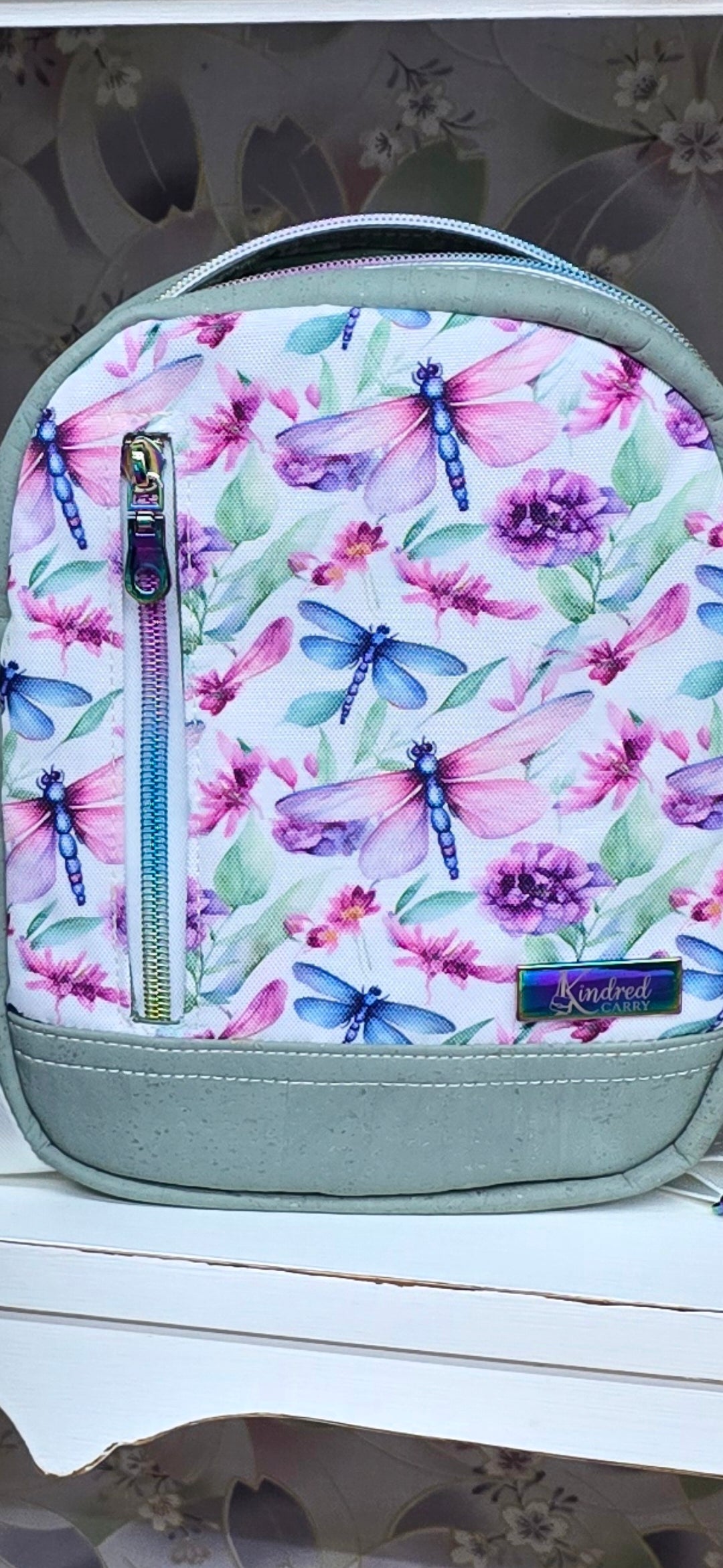 Kindred Carry Pebble bag in rainbow dragonfly print