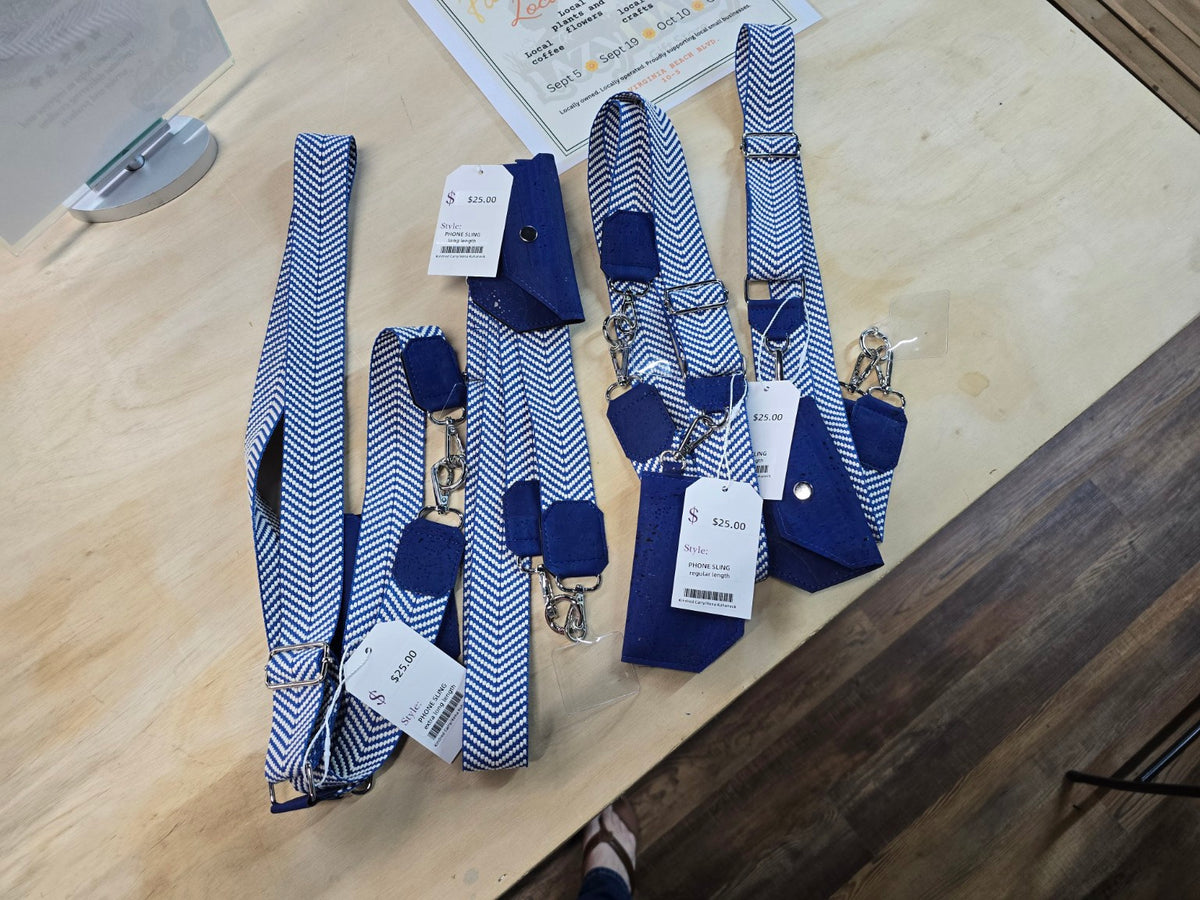 Kindred Carry phone slings with navy and white herringbone webbing and navy cork accents in multiple lengths