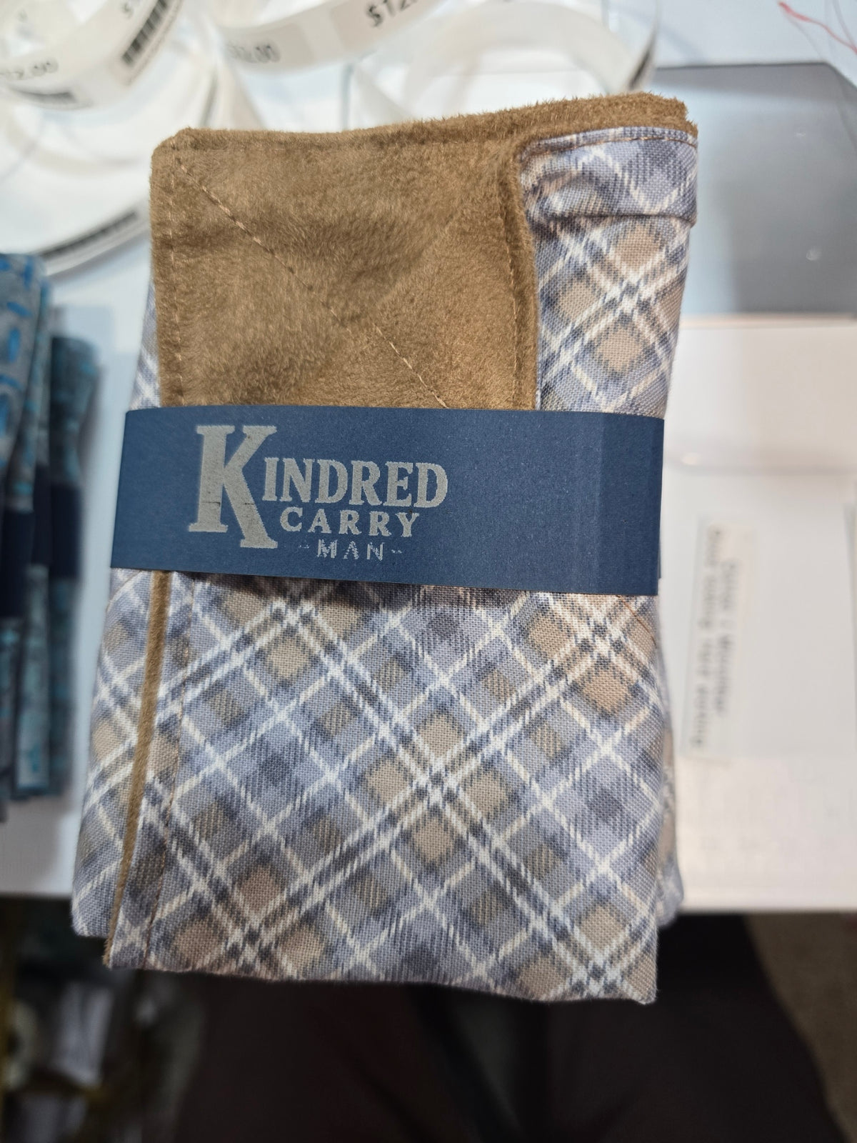 Kindred Carry Man Two-Faced Hank in tan and gray plaid cotton with tan microsuede